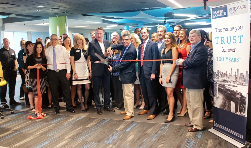 Draper and Kramer Mortgage Corp. employees, Chamber630 members and special guests including Illinois State Rep. David S. Olsen cut the ribbon for the mortgage firm’s new headquarters in Downers Grove, Ill., during a grand opening celebration on August 22