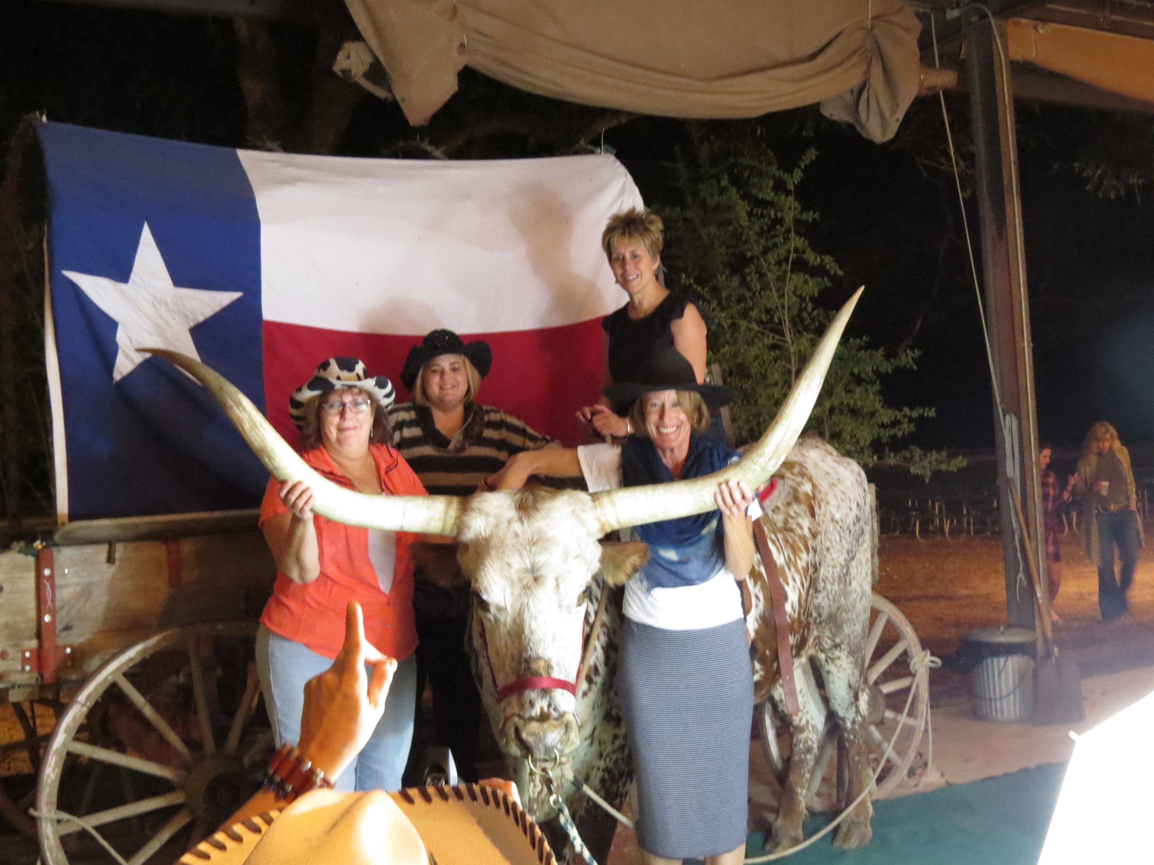 A great time was had by all, as attendees pause for a photo with a Texas Longhorn