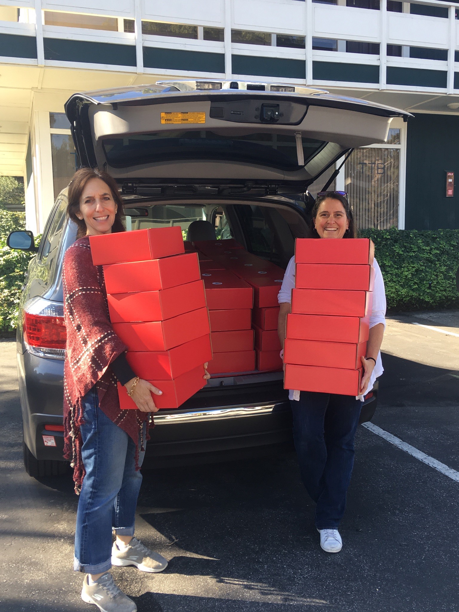 First delivery on its way by Founder and President Lauren Dennis-Perelmuter [left] and Volunteer Director [right] for Art To Grow On's Holiday Art Box Campaign