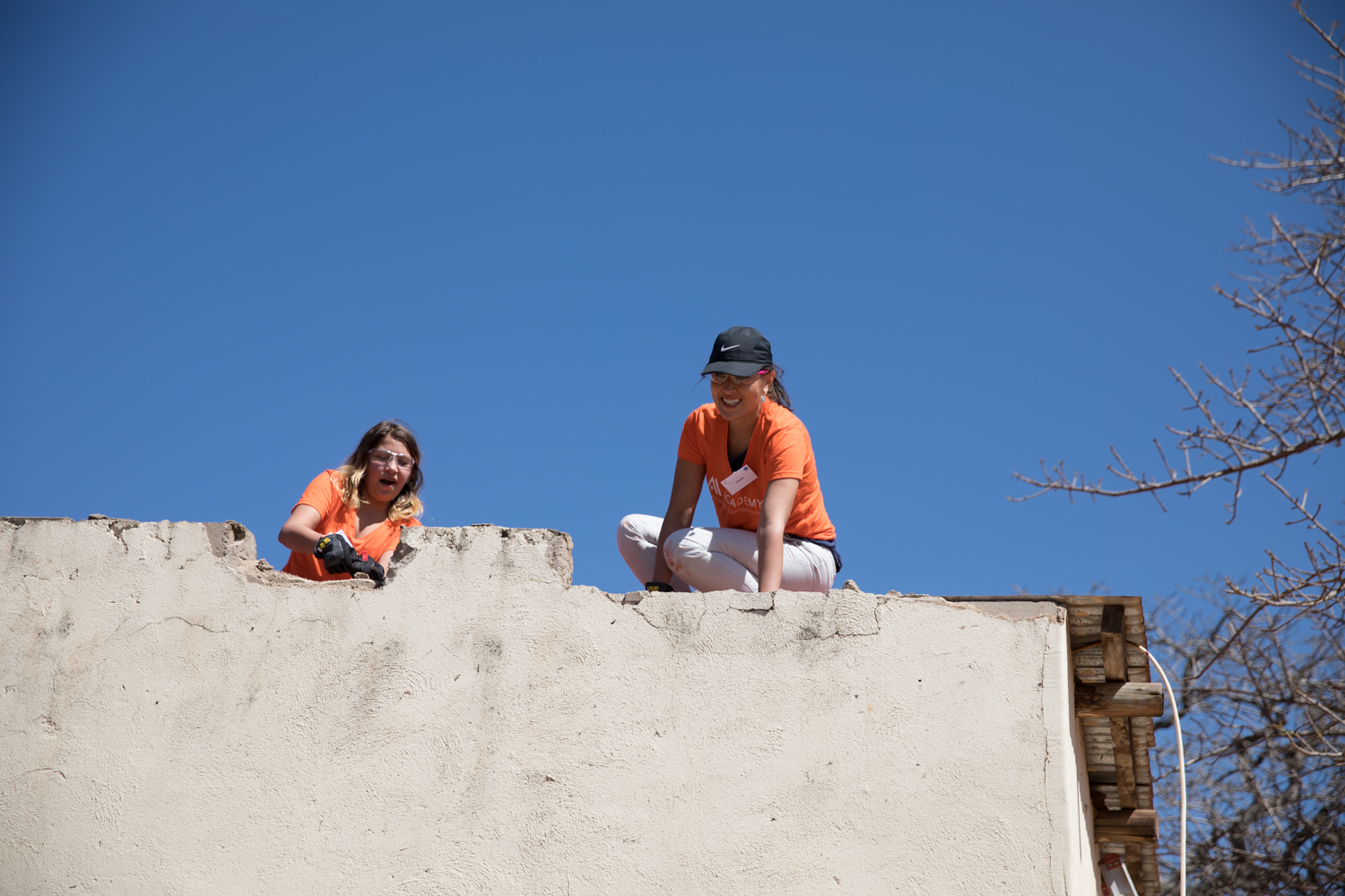 Charadie Finkle repairs a rooftop at The Makwetse School