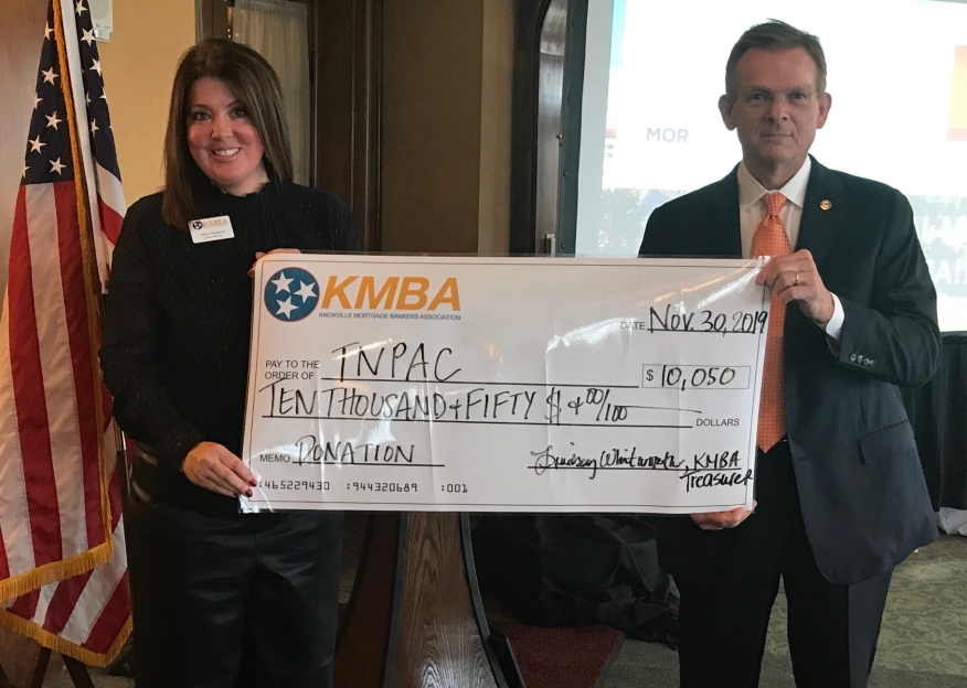 Aimee McIlveen, member of the KMBA Board of Directors, delivers a check for over $10,000 for TNPAC to TNMBA President Jeff Tucker