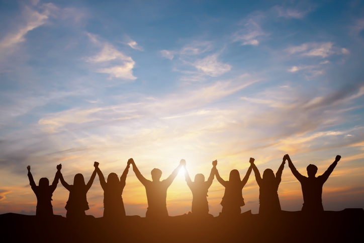 Silhouette of happy business team making high hands in sunset sky background for business teamwork concept (Photo credit: Getty Images/Moostocker)