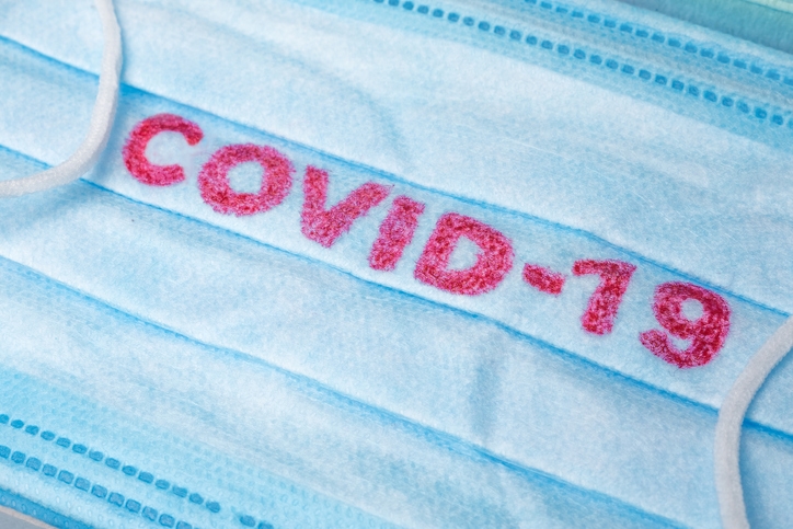 Blue Medical Disposable Face Mask with covid-19 printed on it. Covid-19 - Wuhan Novel Coronavirus pneumonia gets official name from WHO: COVID-19. Disposable breath filter face mask with earloop (Photo credit: Getty Images/Standart)