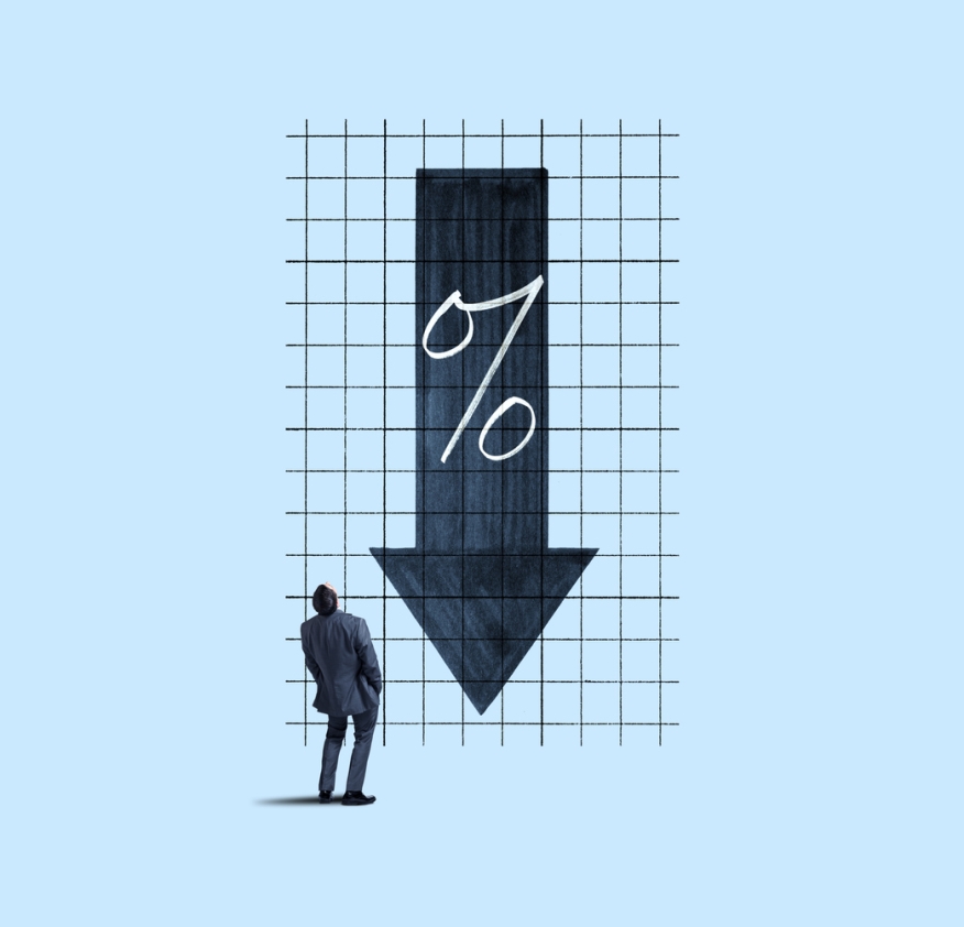Man looking at a grid with a down arrow and percent symbol.