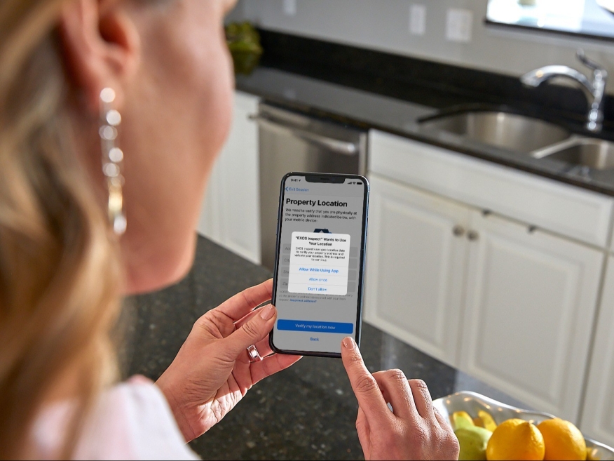 Woman using EXOS Inspect mobile app.
