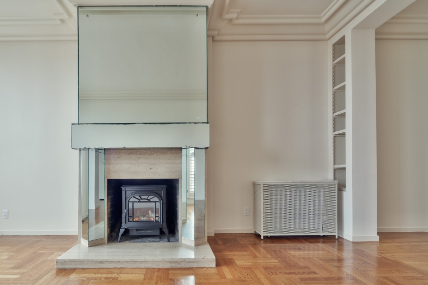 Empty living room with fireplace.