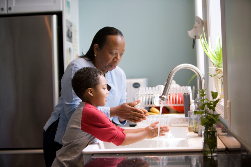 Black mother and son at a sink | Photo by CDC on Unsplash