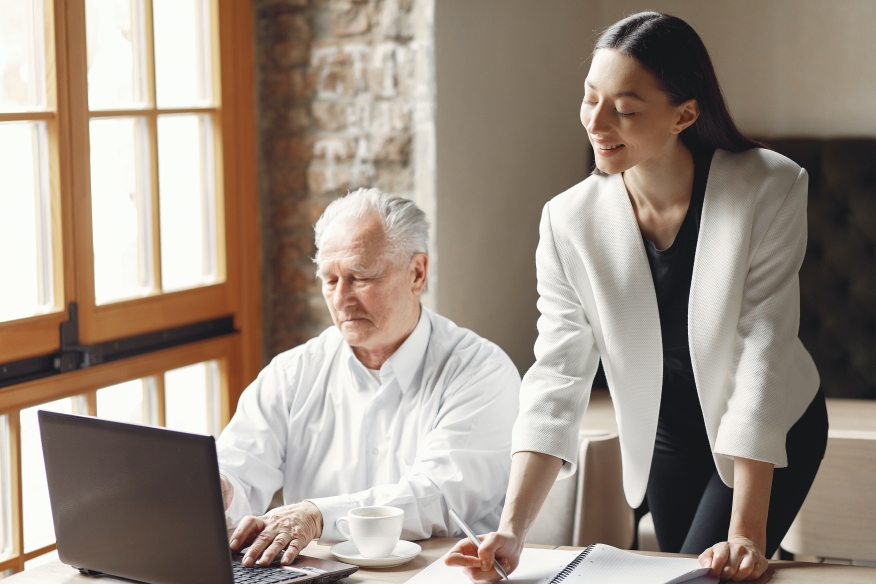 Younger woman advising senior citizen.