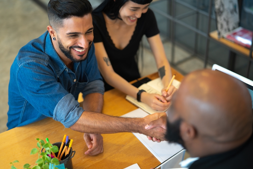 Couple closing a deal on a home. Credit: iStock.com/FGTrade