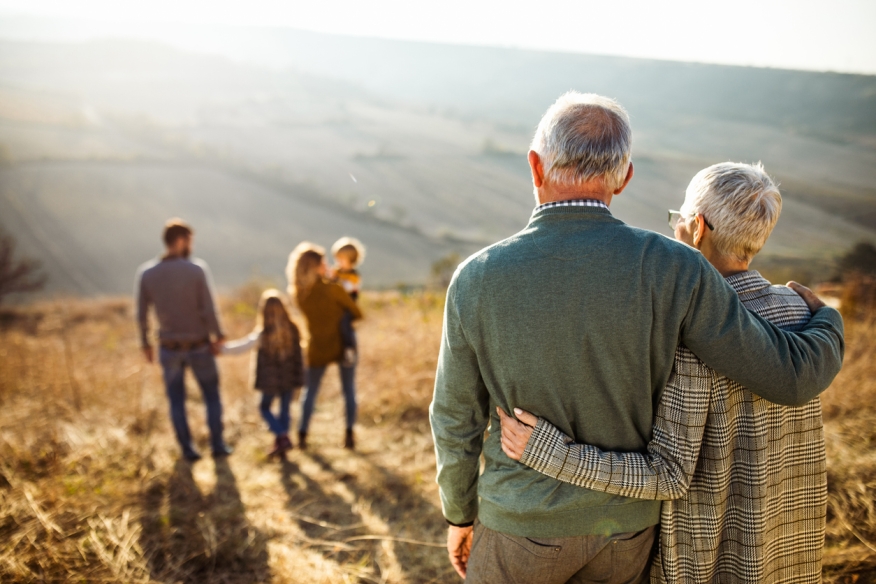 Seniors looking at a younger family. Credit: iStock.com/skynesher