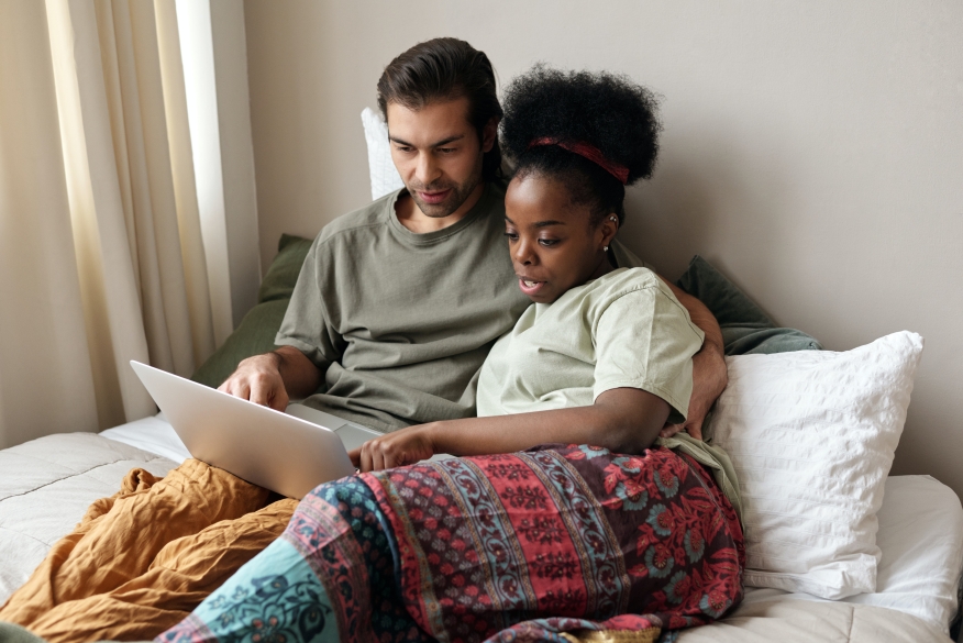 Couple shopping for a new home on the internet.