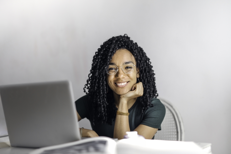 Happy woman using her laptop.