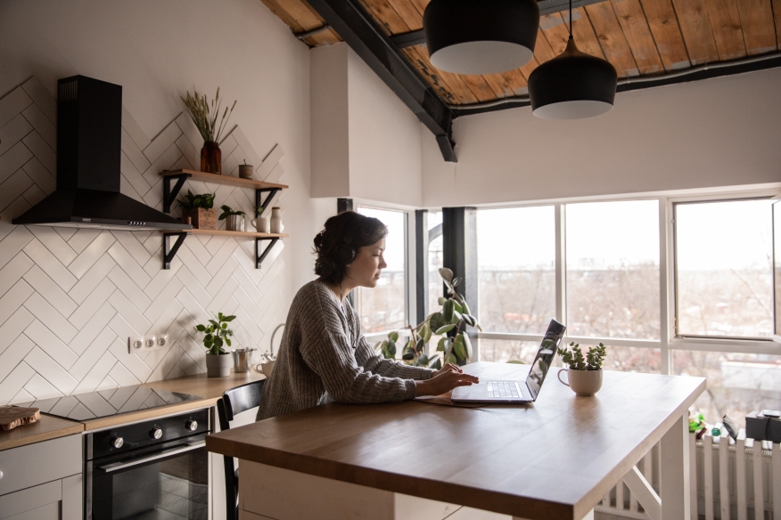 Woman at home working on her laptop.