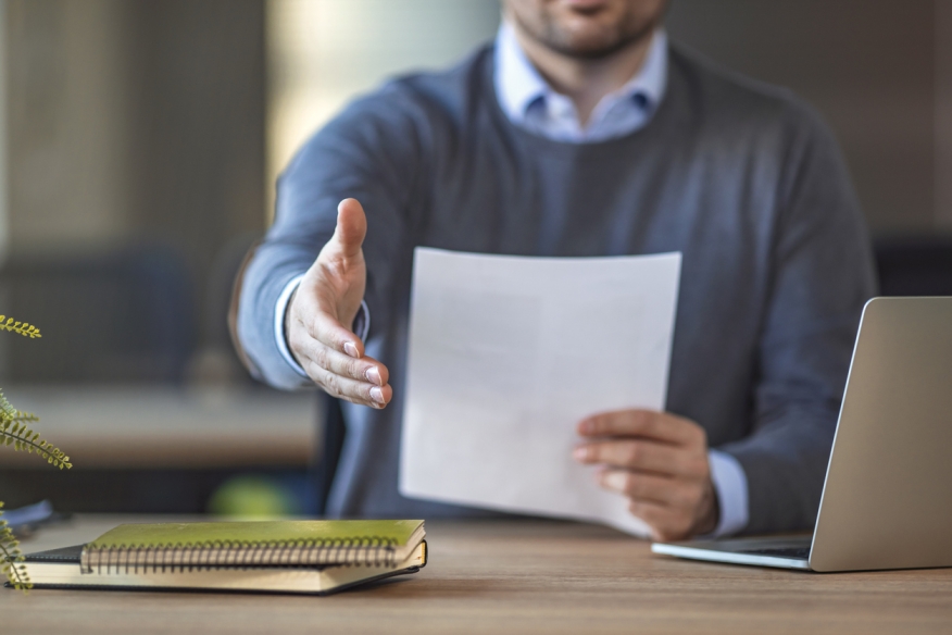 Photo of a man accepting a new job. Photo Credit: iStock.com/dragana991 