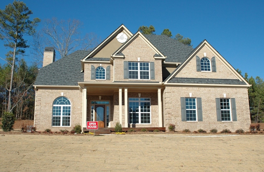 Very nice home for sale with open house sign.