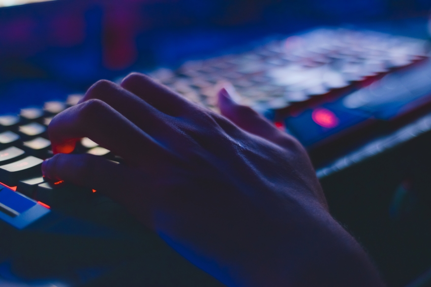 Person using an illuminated keyboard. 