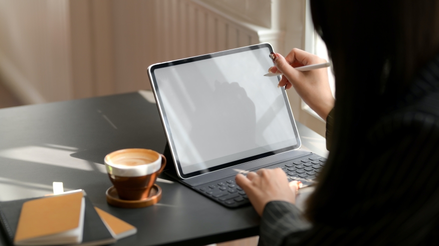 Person using a tablet to sign documents.