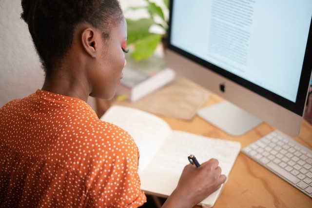 Woman working remotely from her desk at home. 