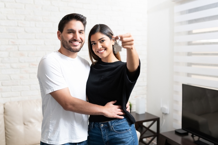 Happy Latin couple after just getting the keys to their home. Credit: iStock.com/Antonio_Diaz