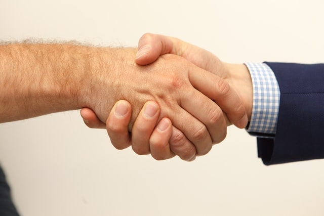 Photo of two people shaking hands.