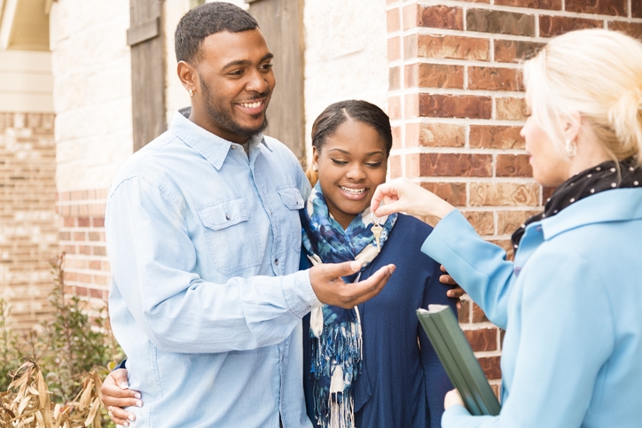 Photo of a couple getting keys to a new home. Credit: iStock.com/fstop123