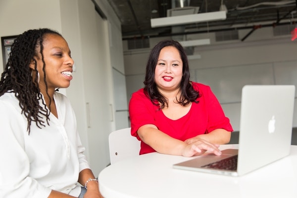 Photo of a woman mentoring another woman. 