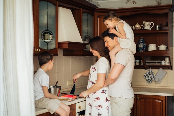 Family at home in their kitchen.