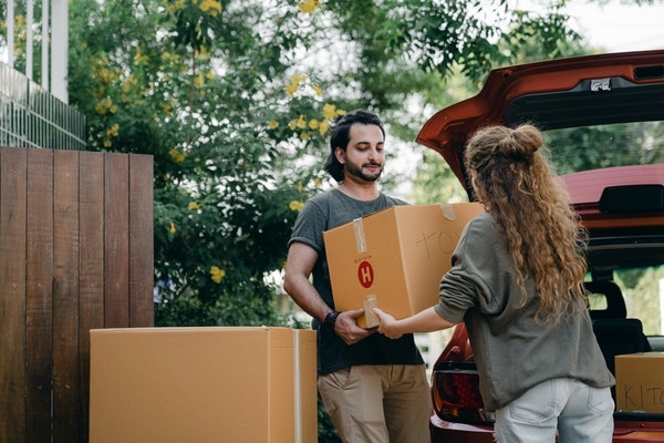 Millennial couple moving in to a home. 