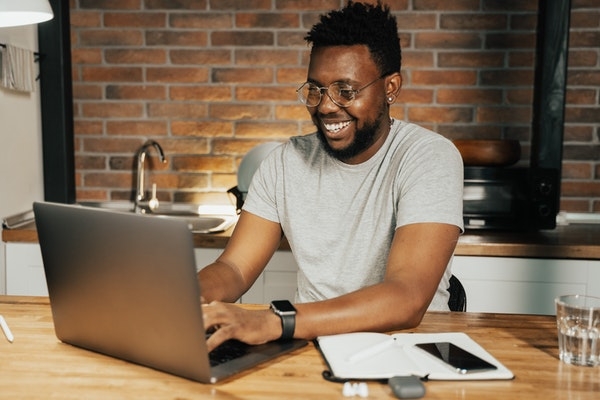 A man at home learning from his online course.