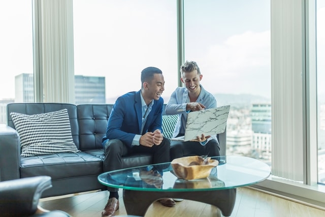 Photo of two millennials in Los Angeles high rise. 