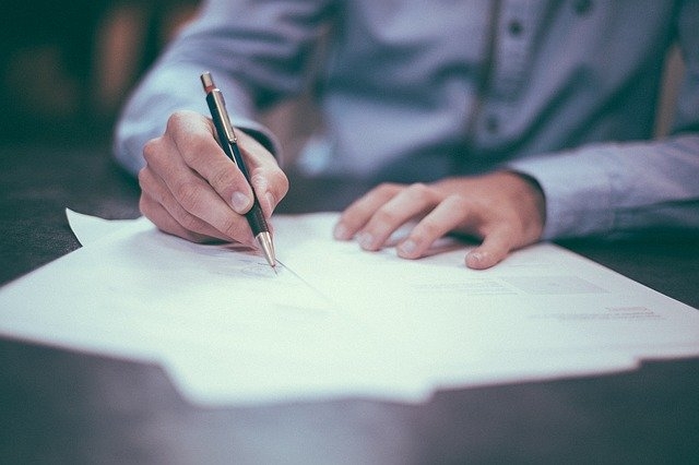 A person signing documents.