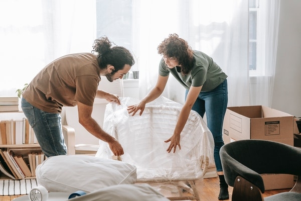 Photo of a couple moving into a new home.