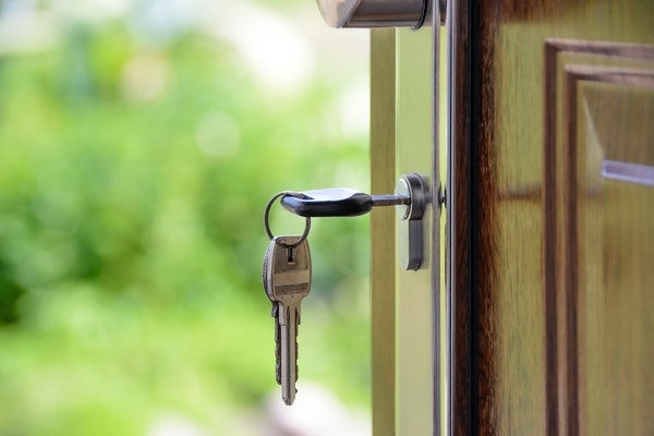 Photo of a front door open with the key in.