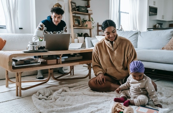 Photo of a millennial family at home in their living room.