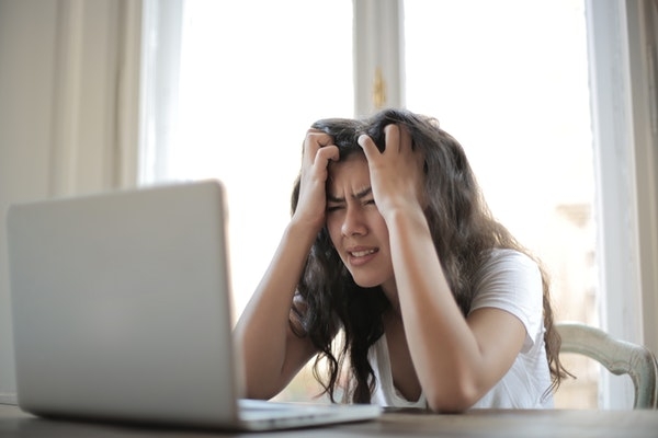 Woman staring at her laptop in frustration.