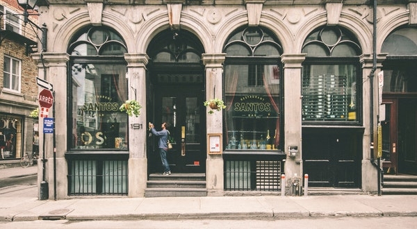 Photo of a man tending to his plant on the first floor of a commercial building. 