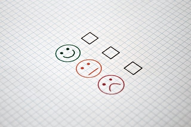 Photo of a simple satisfaction survey with happy, indifferent and sad faces.