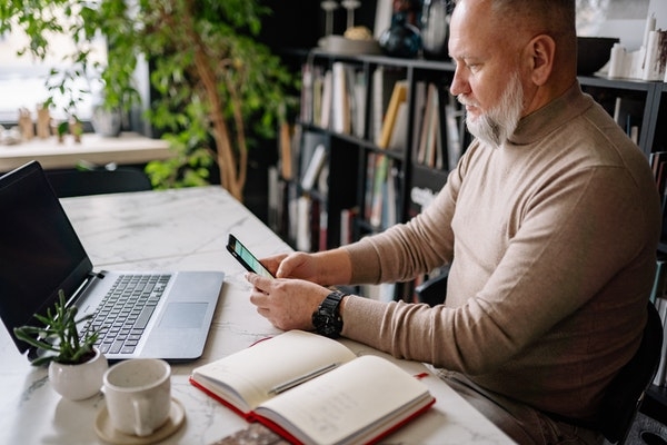 Photo of an older man doing research in his office.