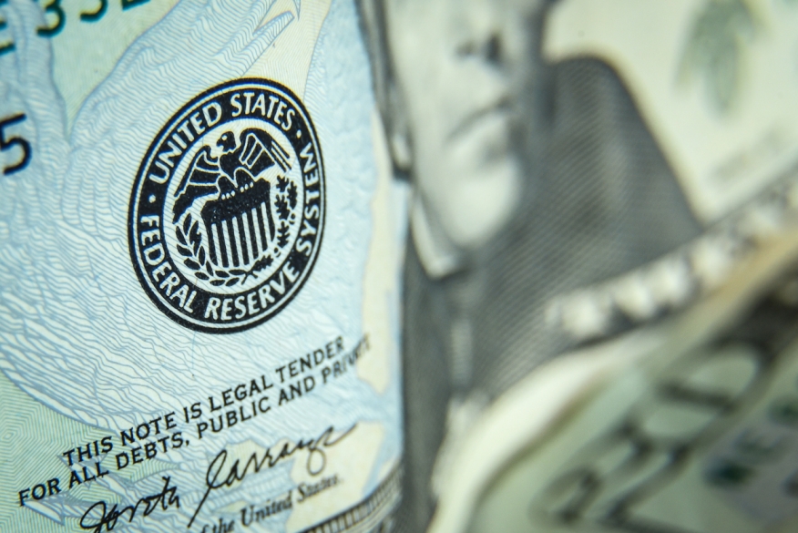 A close-up on the federal reserve seal on a 20 dollar bill.