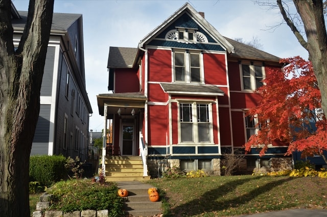 Photo of a red house during the fall.