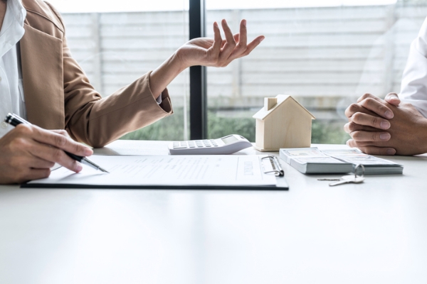 Photo of two people going over their bills and mortgage payment. Credit: iStockphoto.com/Pattanaphong Khuankaew.