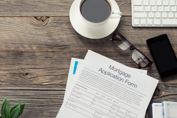 Photo of a mortgage application on a coffee table. Credit: iStockphoto.com/courtneyk.