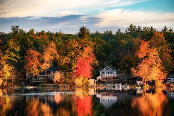 Photo of houses by a lake in Autumn.