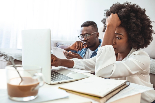 Photo of a Black couple looking frustrated. Credit: iStockphoto.com/dragana991