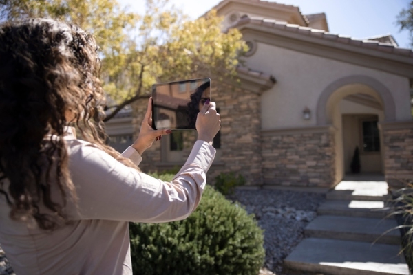 Photo of an appraiser using technology to appraise a home. Credit: iStockphoto.com/LPETTET