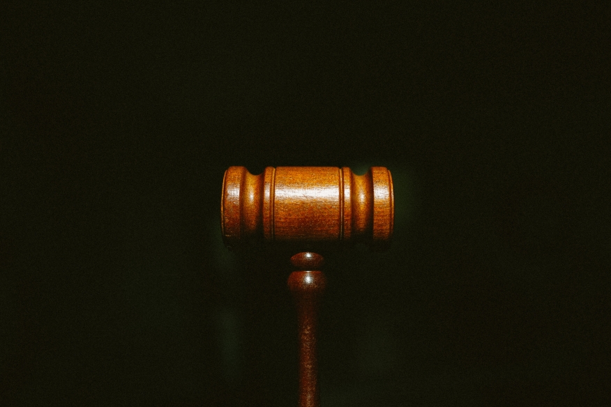 A wooden gavel on black background. 