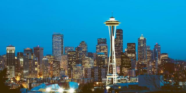 The night skyline of Seattle, host city of the Great Northwest Mortgage Expo.