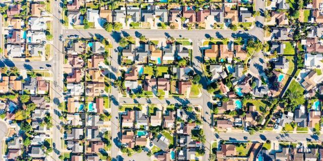 An overhead shot of many colored suburban homes in Irvine, CA, host of the California Mortgage Expo