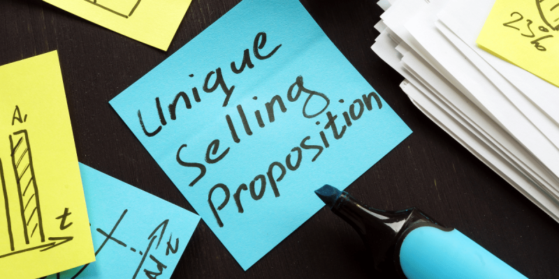 A blue sticky note reads, "Unique Selling Proposition"