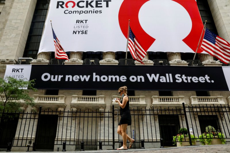 A Rocket Companies advertisement on Wall Street reads, "Our new home on Wall Street."